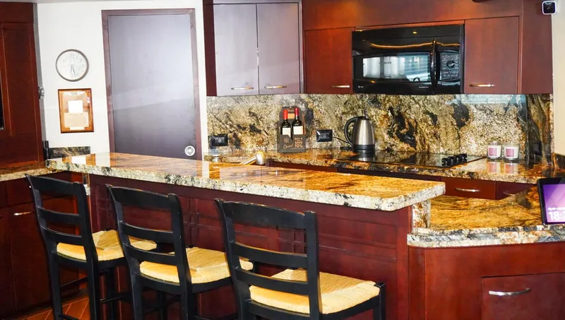 Slide: The Image of Luxurious kitchen in 1990 Hatteras 62 Cockpit Motor Yacht with granite countertops and modern appliances. - 36