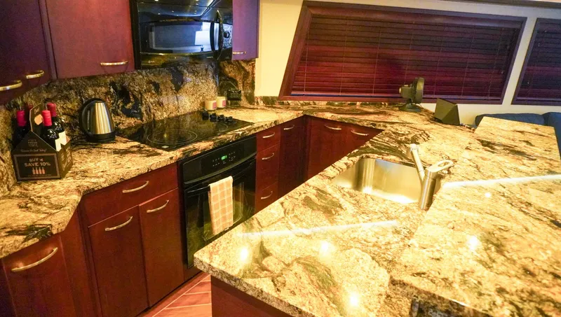 Slide: The Image of Luxurious kitchen in 1990 Hatteras 62 Cockpit Motor Yacht with granite countertops. - 38