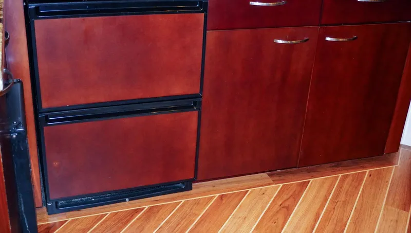 Slide: The Image of Wooden cabinetry and flooring inside a 1990 Hatteras 62 Cockpit Motor Yacht. - 39