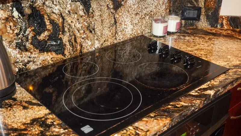 Slide: The Image of Granite countertop with electric cooktop on 1990 Hatteras 62 Cockpit Motor Yacht. - 44