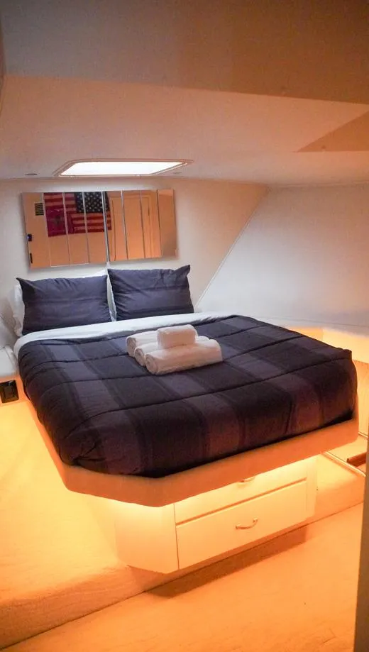 Slide: The Image of Luxurious bedroom in 1990 Hatteras 62 Cockpit Motor Yacht with modern decor. - 47