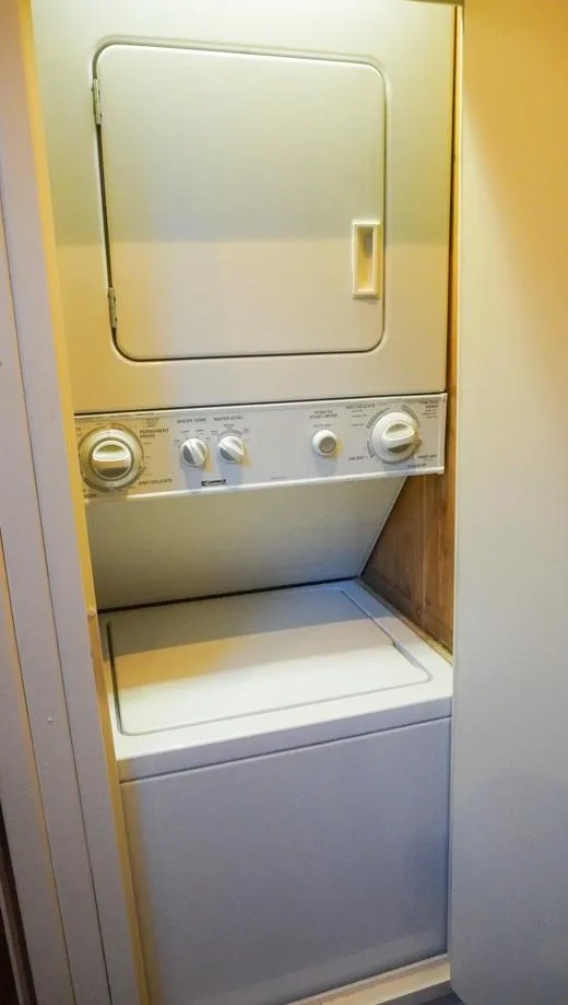 Slide: The Image of Stacked washer and dryer unit inside 1990 Hatteras 62 Cockpit Motor Yacht. - 49