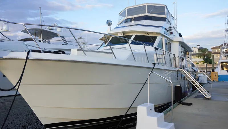 Slide: The Image of 1990 Hatteras 62 Cockpit Motor Yacht docked at marina. - 5