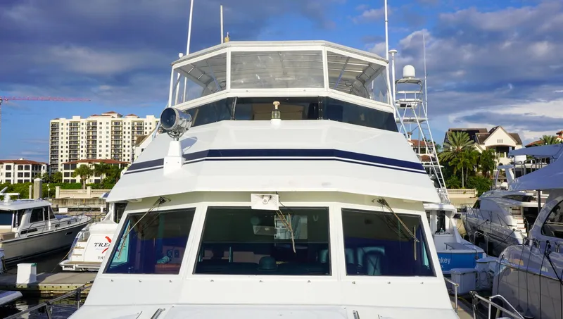 Slide: The Image of 1990 Hatteras 62 Cockpit Motor Yacht docked at marina under blue sky. - 6