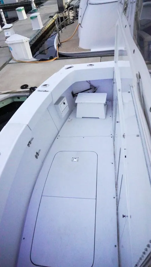 Slide: The Image of 1990 Hatteras 62 Cockpit Motor Yacht, spacious deck view at marina. - 7