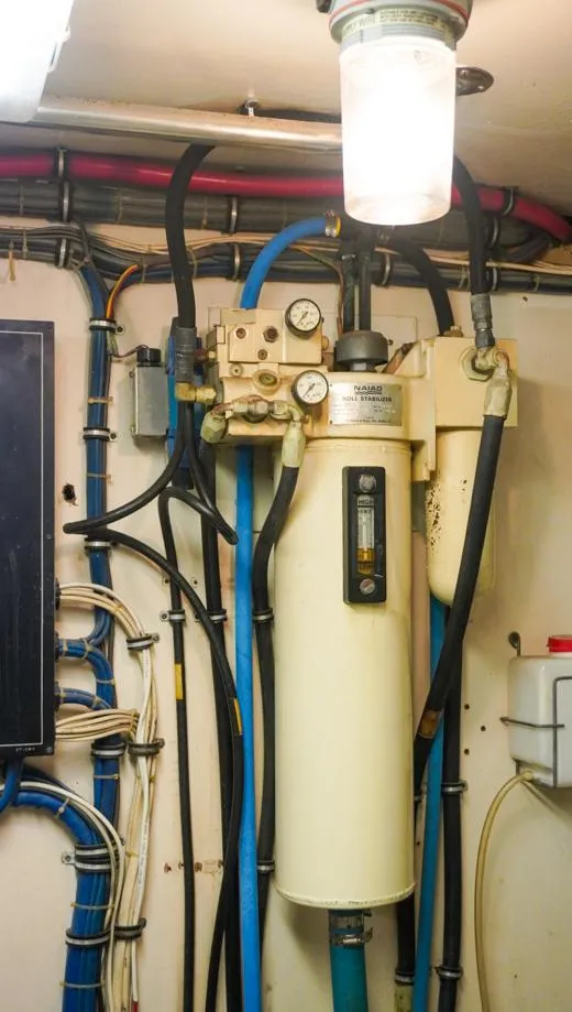 Slide: The Image of Engine room of 1990 Hatteras 62 Cockpit Motor Yacht with mechanical equipment and wiring. - 9