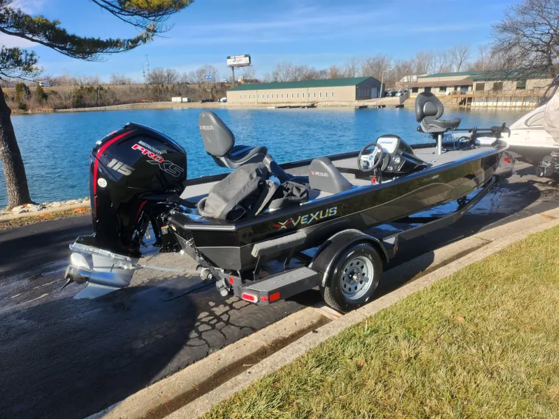 Slide: The Image of 2020 Vexus AVX1880 boat by a lake, featuring a powerful outboard motor. - 11