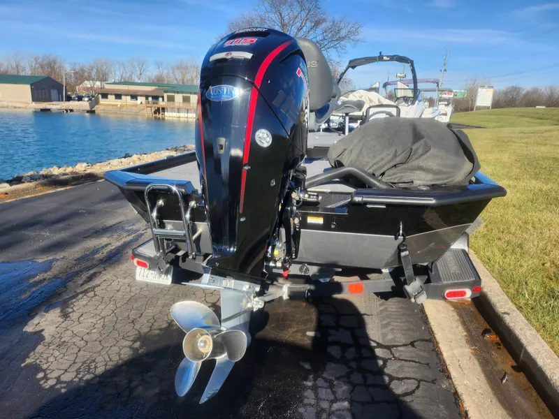 Slide: The Image of 2020 Vexus AVX1880 boat with outboard motor on trailer by a lake. - 2
