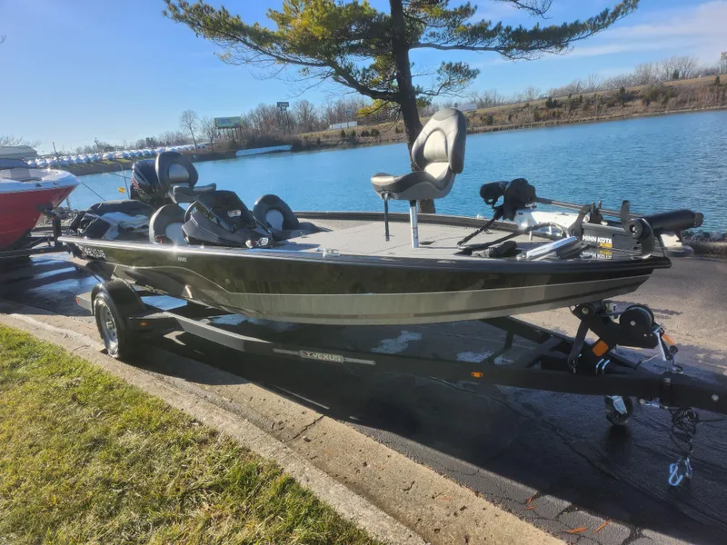 Slide: The Image of 2020 Vexus AVX1880 boat on trailer by a lake, under clear blue sky. - 9