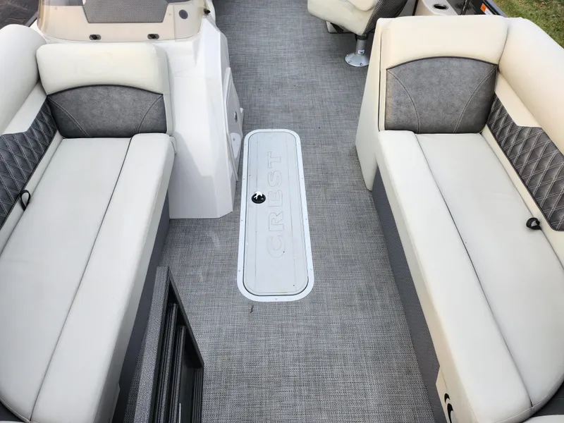 Slide: The Image of 2020 Crest Classic DLX 220 SLC boat interior with gray seating and flooring. - 10