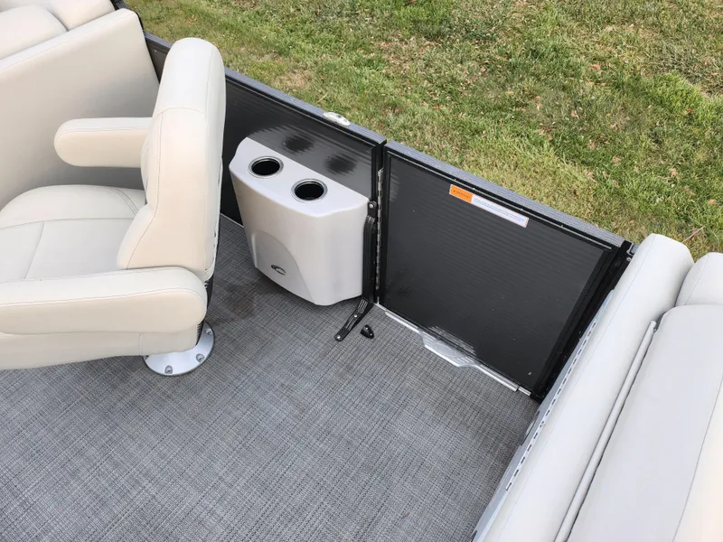 Slide: The Image of 2020 Crest Classic DLX 220 SLC boat interior with beige seating and cup holders. - 14