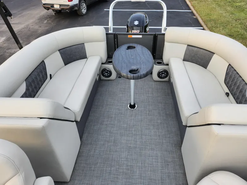 Slide: The Image of 2020 Crest Classic DLX 220 SLC pontoon boat interior with plush seating and table. - 15