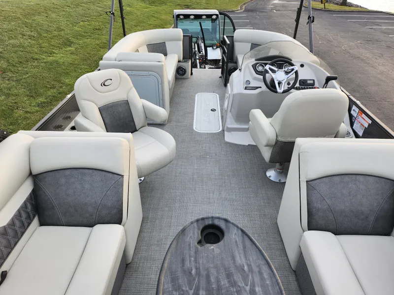 Slide: The Image of 2020 Crest Classic DLX 220 SLC pontoon boat interior with plush seating and modern helm. - 17
