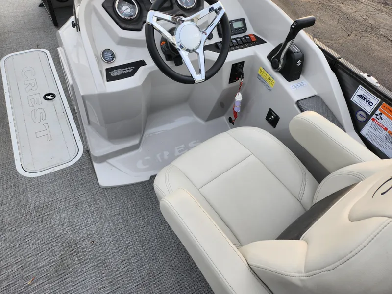 Slide: The Image of 2020 Crest Classic DLX 220 SLC boat interior with steering wheel and captain's chair. - 18