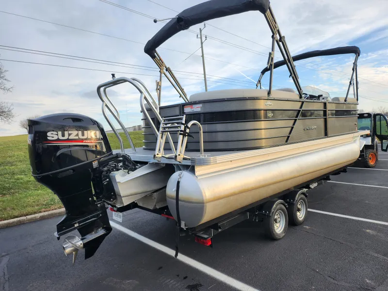 Slide: The Image of 2020 Crest Classic DLX 220 SLC pontoon boat with Suzuki outboard motor on trailer. - 3