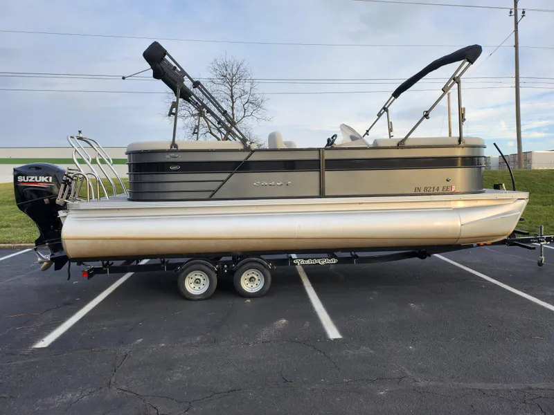 Slide: The Image of 2020 Crest Classic DLX 220 SLC pontoon boat on trailer, featuring Suzuki outboard motor. - 4