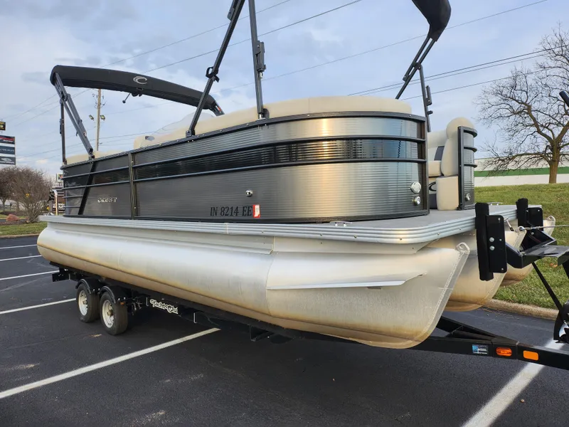 Slide: The Image of 2020 Crest Classic DLX 220 SLC pontoon boat on trailer in parking lot. - 5