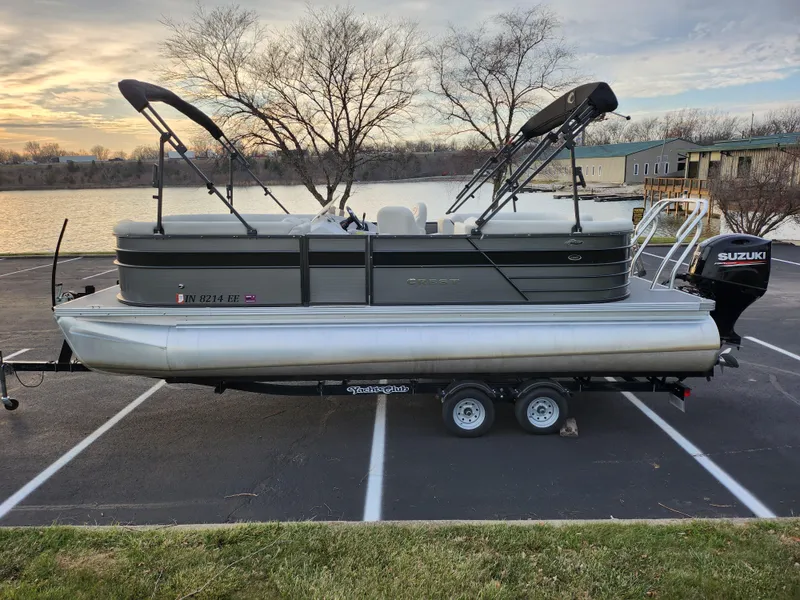 Slide: The Image of 2020 Crest Classic DLX 220 SLC pontoon boat on trailer by lakeside. - 9