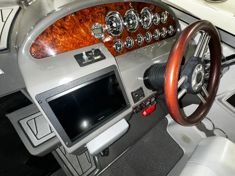 Slide: The Image of 2011 Regal 3060 Window Express dashboard with wood accents and modern controls. - 19