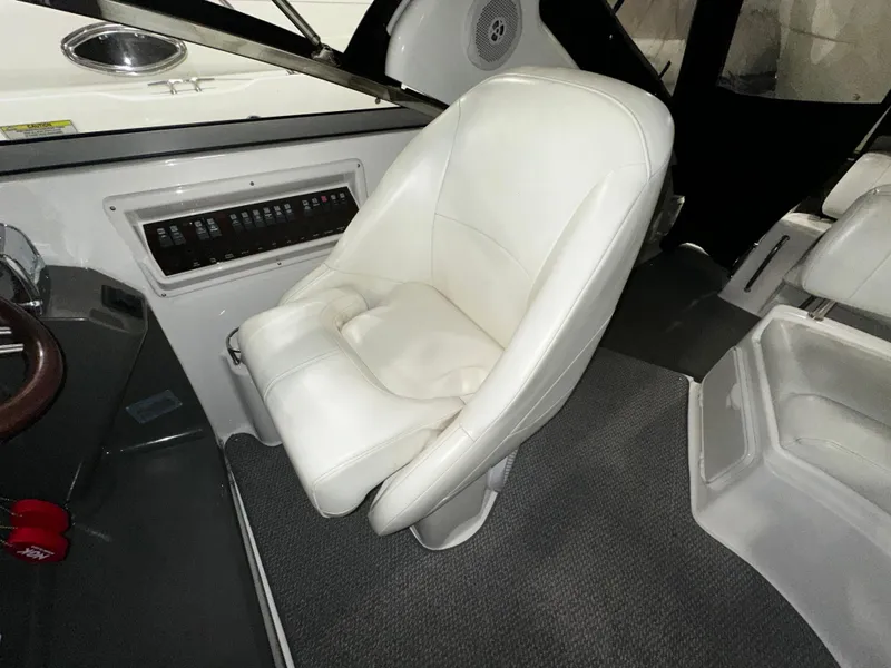 Slide: The Image of 2011 Regal 3060 Window Express interior with white captain's chair and control panel. - 20