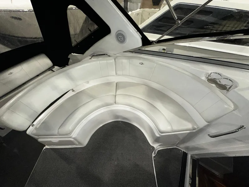 Slide: The Image of 2011 Regal 3060 Window Express boat interior with curved white seating. - 22