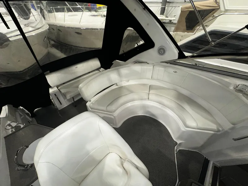 Slide: The Image of Interior of 2011 Regal 3060 Window Express boat with white seating and carpeted floor. - 23