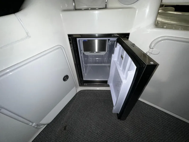 Slide: The Image of Open mini fridge inside 2011 Regal 3060 Window Express boat cabin. - 24