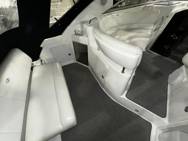 Slide: The Image of Interior of 2011 Regal 3060 Window Express boat with white seating and carpeted floor. - 25