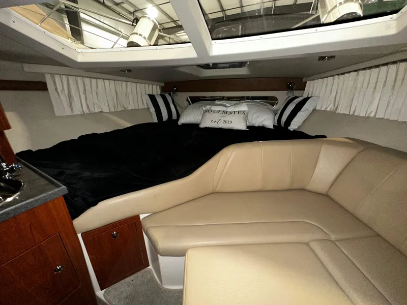 Slide: The Image of 2011 Regal 3060 Window Express cabin interior with cozy seating and bedding. - 28