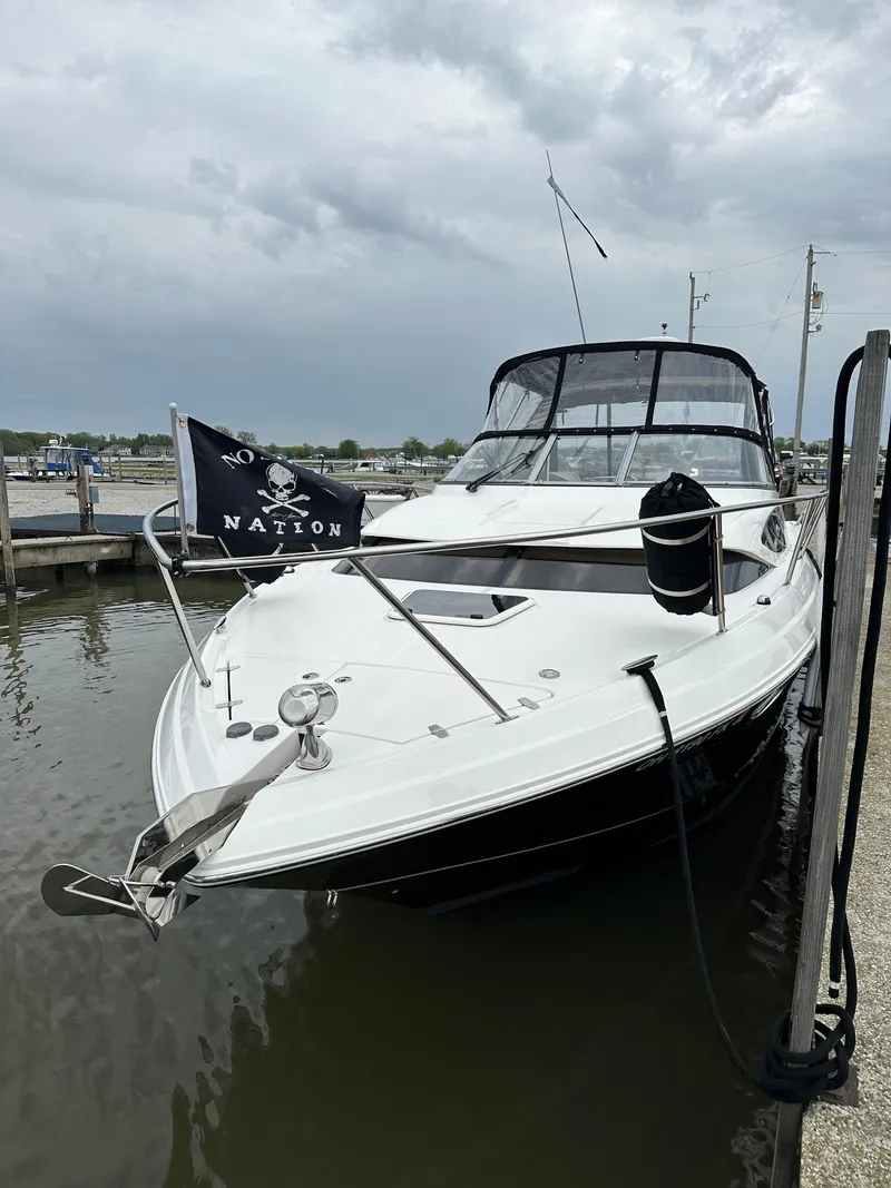 Slide: The Image of 2011 Regal 3060 Window Express boat docked with pirate flag. - 3