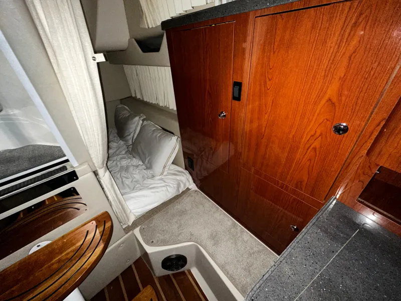 Slide: The Image of 2011 Regal 3060 Window Express cabin interior with wood cabinetry and cozy sleeping area. - 31