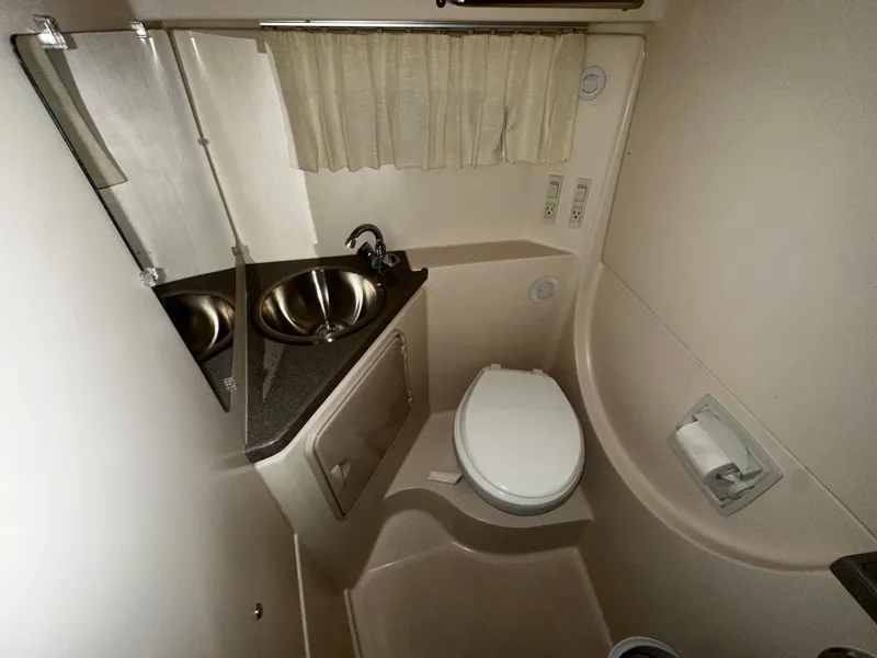 Slide: The Image of 2011 Regal 3060 Window Express bathroom with sink, toilet, and mirror. - 33