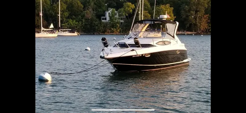 Slide: The Image of 2011 Regal 3060 Window Express boat anchored on a serene lake. - 4