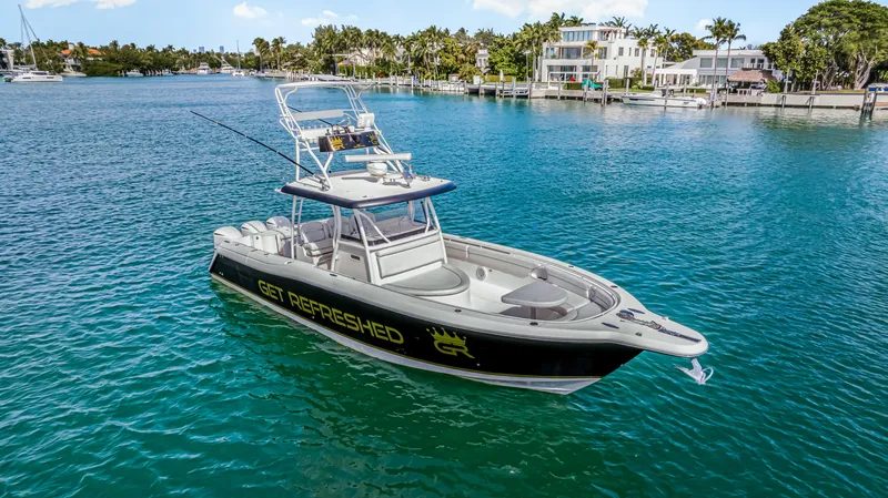 Slide: The Image of 2016 Stamas 390 Tarpon boat on clear blue water near a coastal residential area. - 10