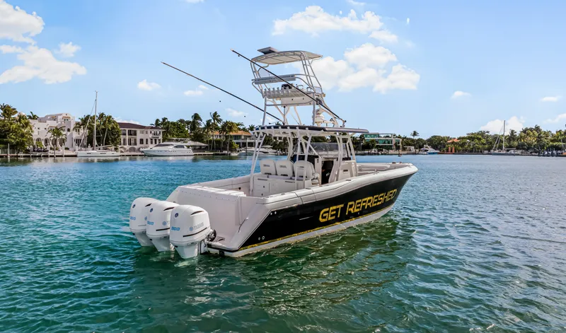Slide: The Image of 2016 Stamas 390 Tarpon boat on water, featuring triple outboard engines. - 11