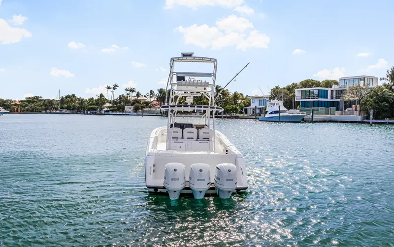 Slide: The Image of 2016 Stamas 390 Tarpon boat on water, rear view with triple engines. - 12
