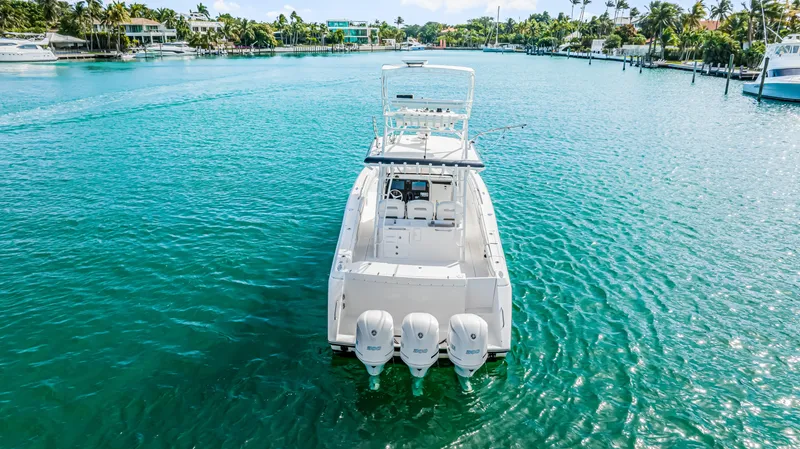 Slide: The Image of 2016 Stamas 390 Tarpon boat on clear blue water, rear view with four engines. - 13