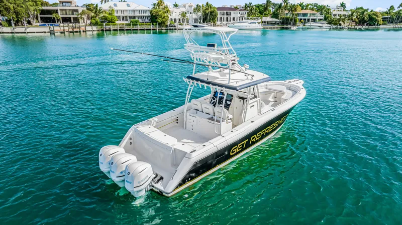 Slide: The Image of 2016 Stamas 390 Tarpon boat on clear blue water, featuring triple outboard engines. - 14