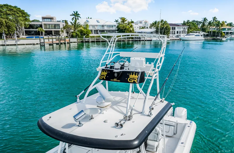 Slide: The Image of 2016 Stamas 390 Tarpon boat on turquoise water near luxury waterfront homes. - 16