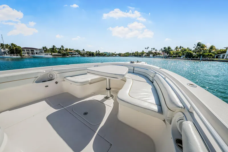 Slide: The Image of 2016 Stamas 390 Tarpon boat interior with seating and table, overlooking a scenic waterfront. - 23