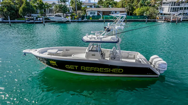 Slide: The Image of 2016 Stamas 390 Tarpon boat on water, "Get Refreshed" text on side. - 3