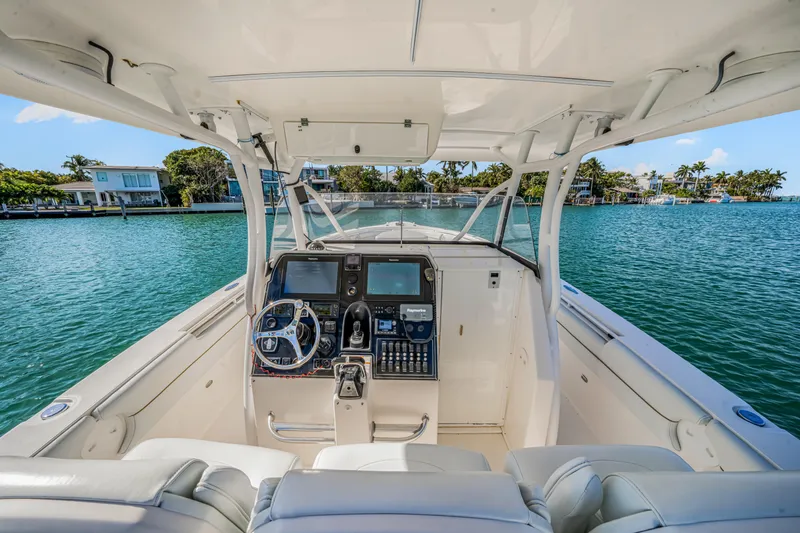 Slide: The Image of 2016 Stamas 390 Tarpon boat interior with steering console on a sunny day. - 33
