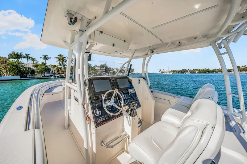Slide: The Image of 2016 Stamas 390 Tarpon boat interior with helm, white seating, and ocean view. - 34