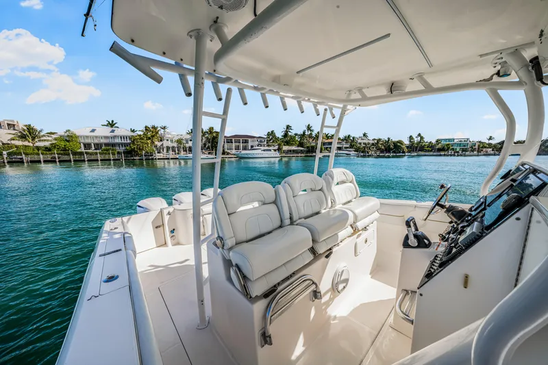 Slide: The Image of 2016 Stamas 390 Tarpon boat interior with white seating, steering console, and waterfront view. - 36