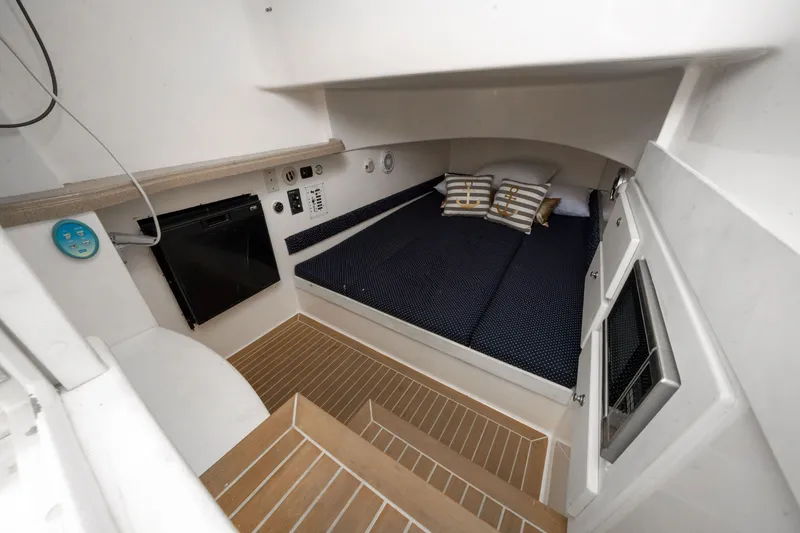 Slide: The Image of 2016 Stamas 390 Tarpon cabin interior with bed, pillows, and wooden flooring. - 46