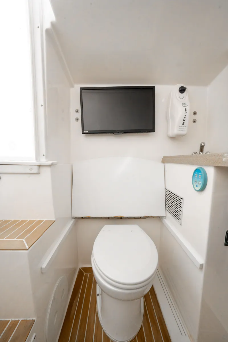Slide: The Image of Interior of 2016 Stamas 390 Tarpon boat bathroom with toilet and wall-mounted TV. - 49