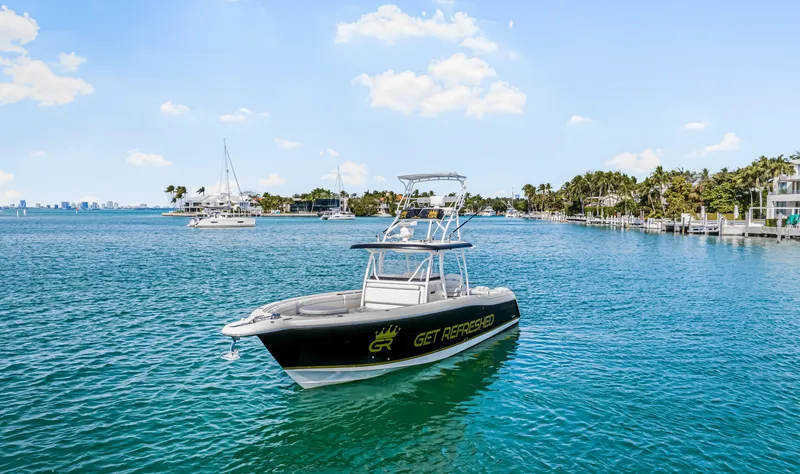 Slide: The Image of 2016 Stamas 390 Tarpon boat on clear blue water, sunny day, coastal background. - 5
