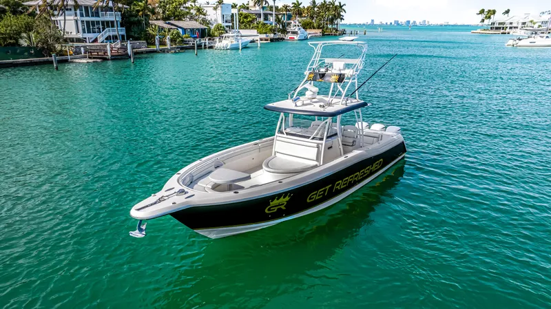 Slide: The Image of 2016 Stamas 390 Tarpon boat on turquoise water near coastal homes. - 6