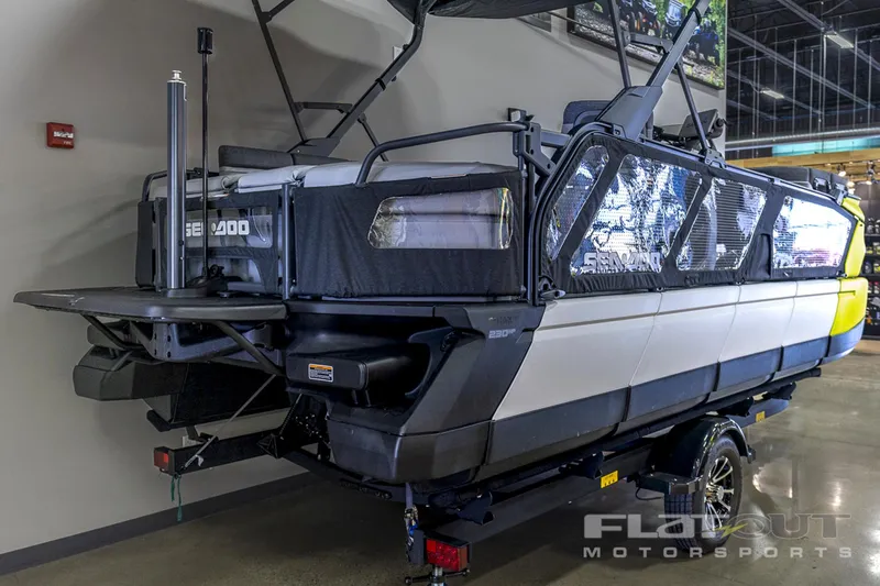 Slide: The Image of 2024 Sea-Doo SWITCH Cruise 21, 230HP, showcased indoors, available with $12,000 savings. - 2