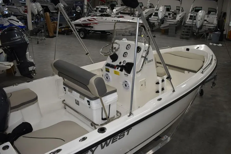 Slide: The Image of 2025 Key West 1720 CC boat interior with console and seating in showroom. - 10